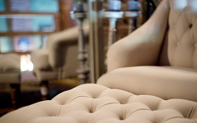 A close-up shot of a curved bouclé armchair