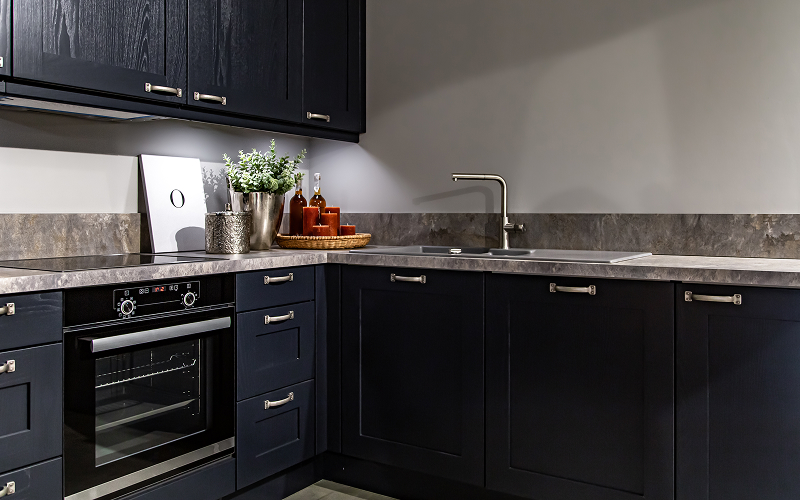An L-shaped HDB kitchen layout with quartz countertops and ample storage.