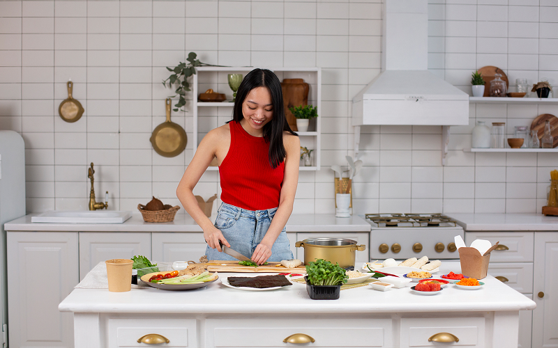 A person cooking in a bright kitchen