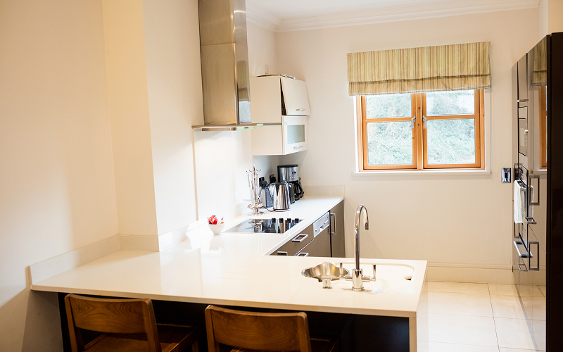 A neatly organised open kitchen with concealed storage and a central island