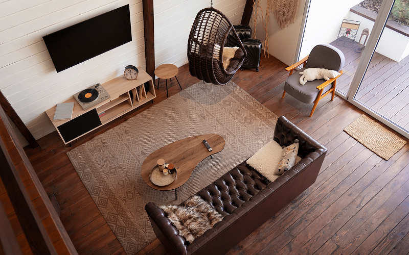 A wide-angle shot of a modern, clutter-free living room with distinct zones.