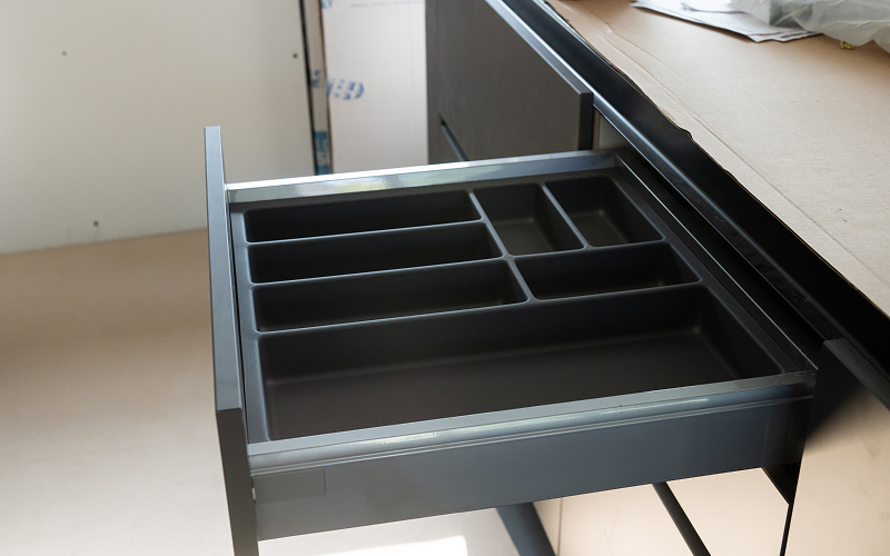 An image of a drawer from under a kitchen counter.