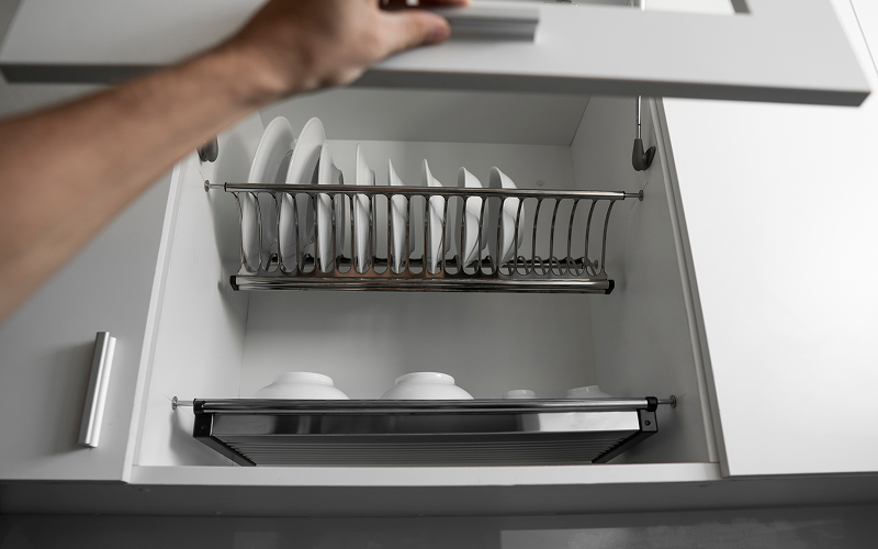 An image of an open kitchen drawer with hooks.