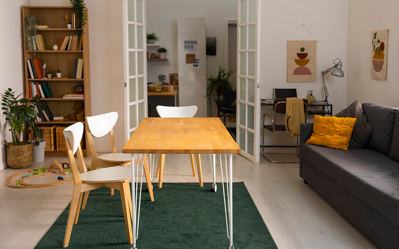 An open-concept condo with colour-coordinated living, dining and kitchen zones