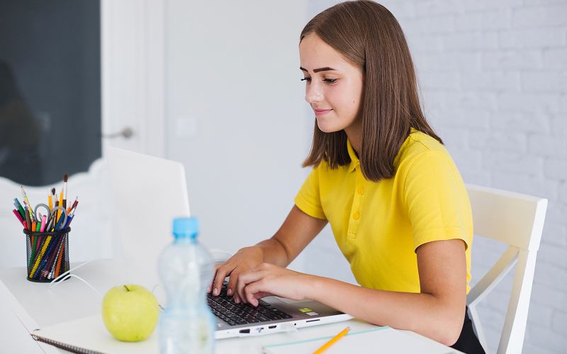Teen using a dedicated study desk or digital setup in a private room.